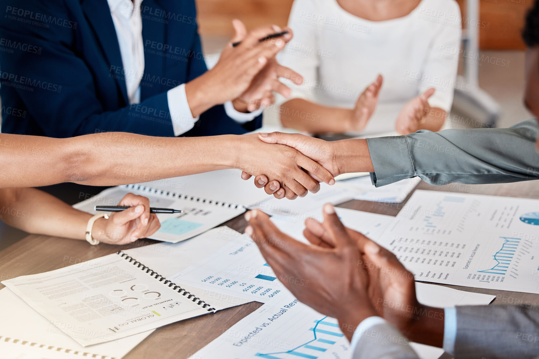 Buy stock photo Success, diversity and a meeting with a handshake in agreement to a deal or contract. Teamwork, success and partnership for growth in business. Support, collaboration and a team working on a report.