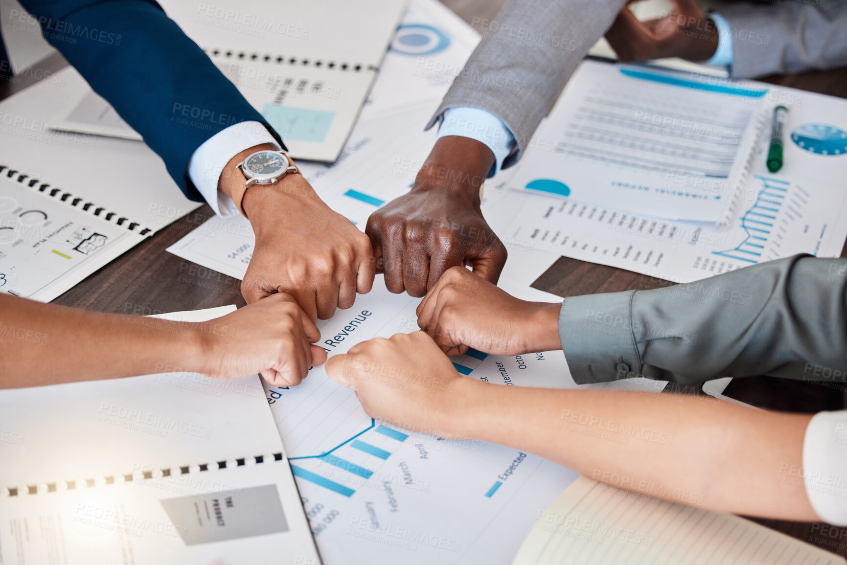 Buy stock photo Hands, teamwork and meeting with a team working in collaboration with paperwork and data and their fists in a circle. Finance, strategy and growth with a group of business people in the boardroom