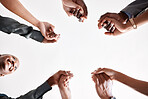 Diversity, support and collaboration of business people holding hands below in trust for company success. Team of corporate workers in a circle of success in a meeting together at a corporate company