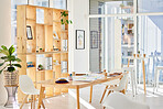 Interior office with light, wood furniture and workplace space for business and work. Bright, modern and minimalist design decoration of a corporate or creative room for working employee or staff