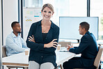 Female leader, manager or CEO with a business woman in a meeting for planning or strategy and her team in the background. Management, leadership and training with a group in a boardroom for training