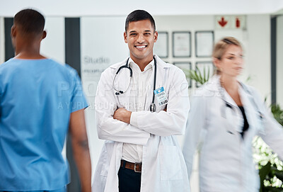 Buy stock photo Happy, medical and doctor in hospital with smile and confident, arms crossed in busy hallway. Male, surgeon and healthcare specialist physician in hospital. Staff, clinical internship.