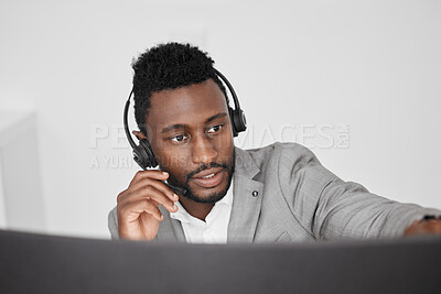 Buy stock photo Call center, customer service and crm representative wearing headset while consulting with customer in telemarketing company. Serious black man in contact us and sales support working on a computer