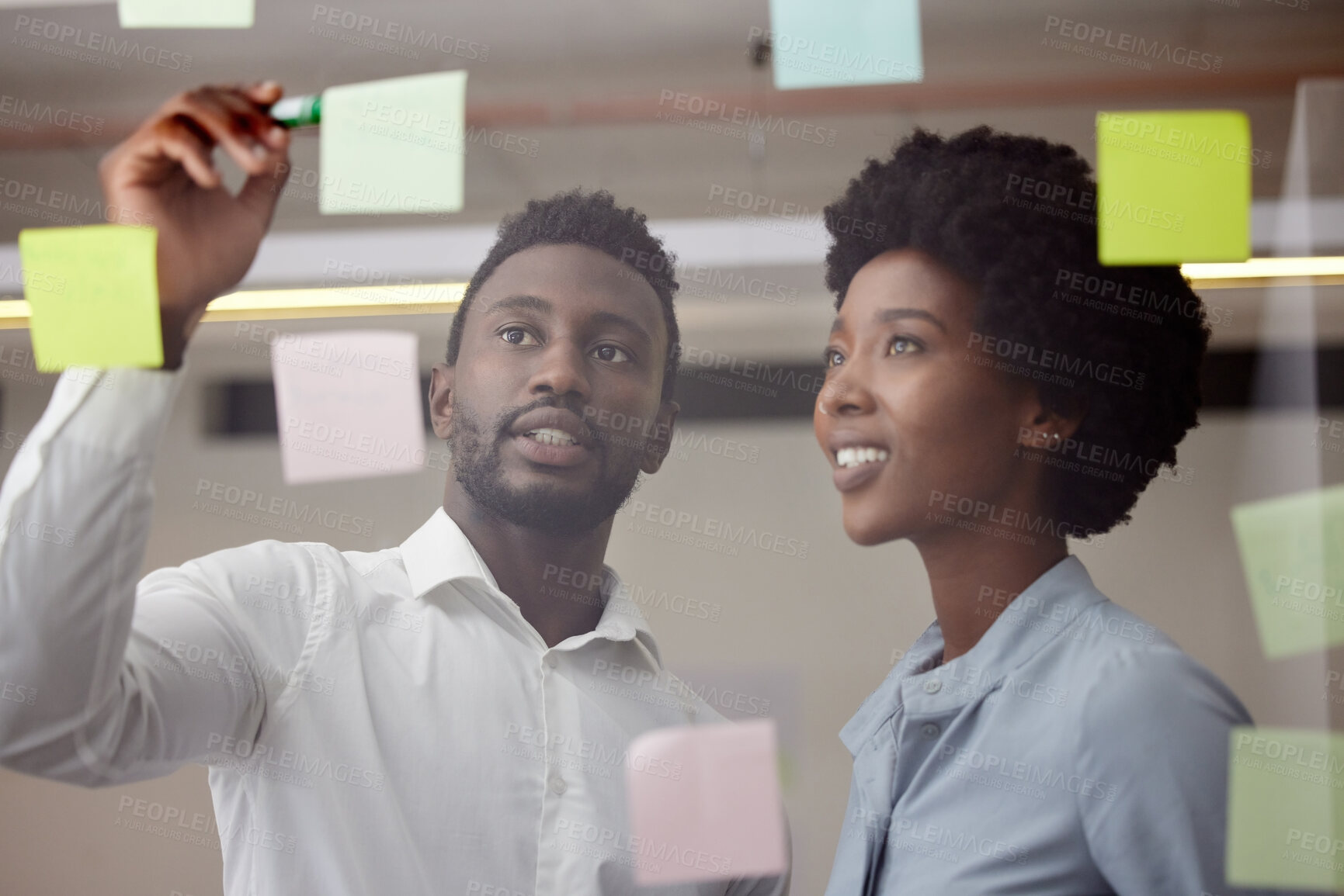 Buy stock photo Black people, writing and thinking of idea on post it wall for brainstorming meeting pitch. Innovation, strategy and development of business goal with professional corporate planning team.
