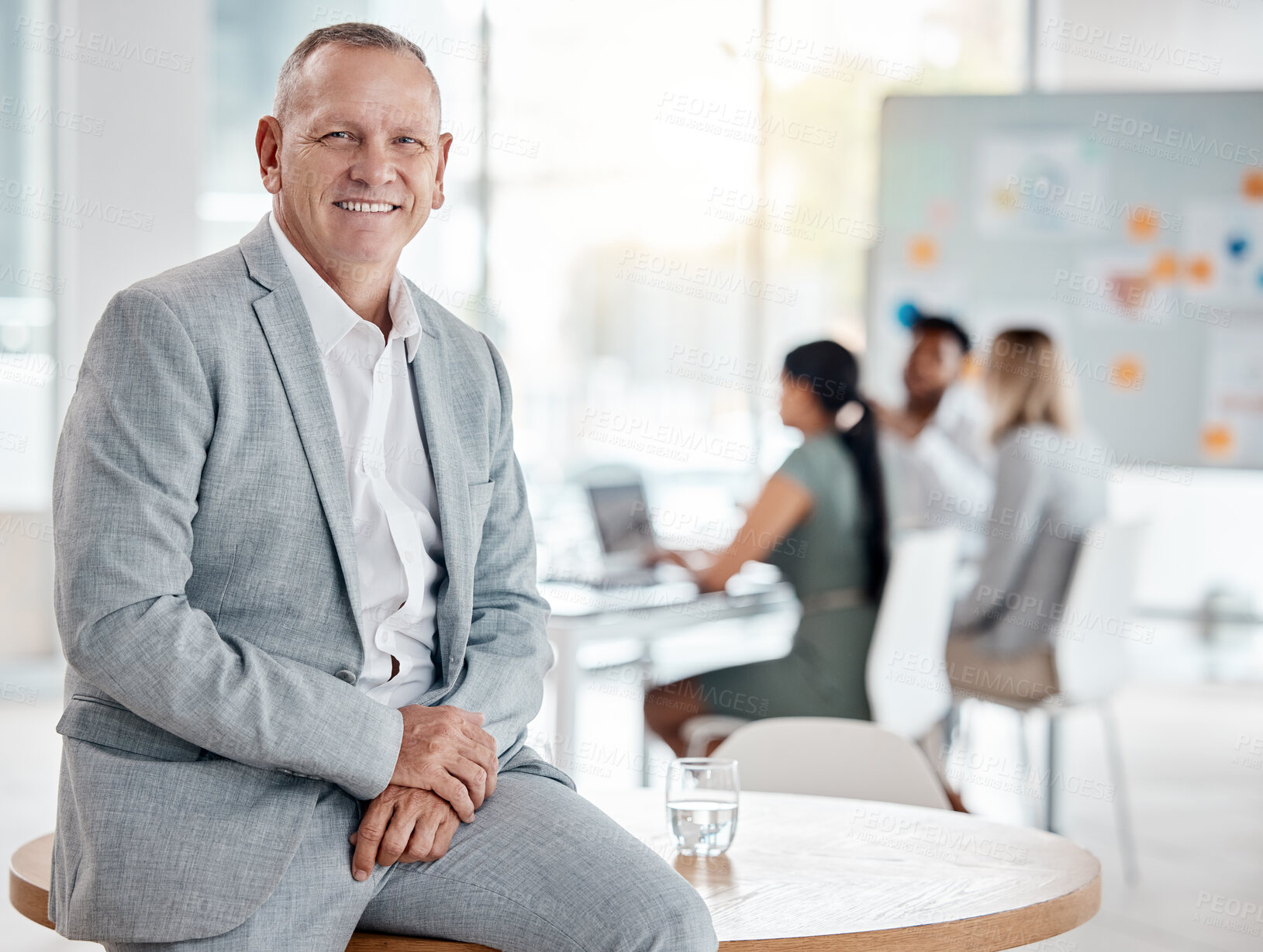 Buy stock photo Portrait, happy business man or ceo in office on table for motivation, inspiration and vision with a smile. Boss, leader or executive with plan for innovation, strategy and future success planning.

