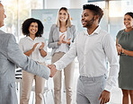 Handshake, promotion and applause with a business man shaking hands with his manager, leader or boss during a meeting in the office. Thank you, partnership and teamwork with a CEO and male employee
