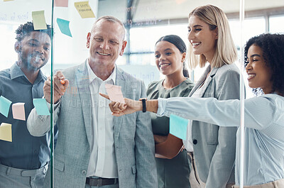 Buy stock photo Business people planning on sticky note in meeting, post it paper for creative advertising idea and team collaboration for marketing project. Teamwork for global company strategy on glass in office
