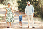 Black family, love and active parents walking with their child through nature for an adventure and outdoor fun. Happy african man and woman with daughter enjoying travel, vacation and leisure walk