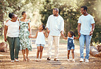 Black big family, love and a walk in nature, outdoors or outside on holiday, vacation or trip. African ancestry, grandmother or children with mother, fathers or siblings together walking at the park
