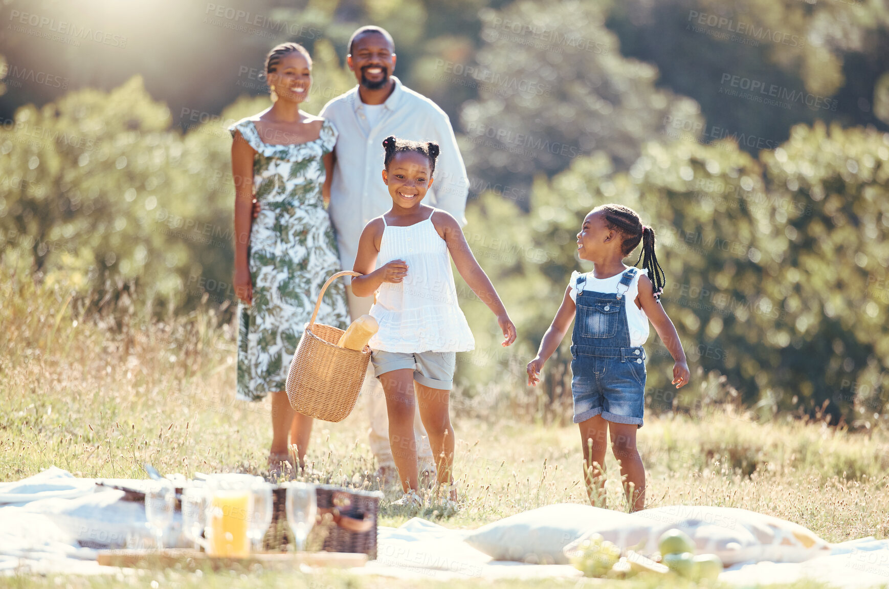 Buy stock photo Black family, summer picnic and children bond with parents on break in remote countryside park field. Smile, happy and love mother, father or playful and fun girls in nature outing with man and woman