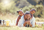 Portrait happy father and children on a nature field during a family picnic in summer together. Man and girl with playful fun outdoor in a nature forest with a smile and love while bonding in spring