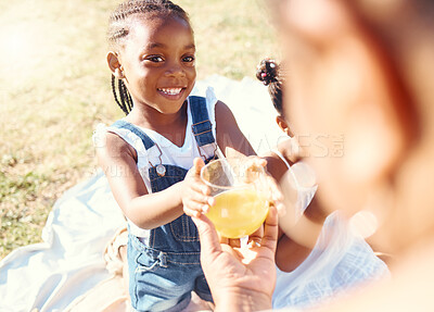 Buy stock photo Happy girl, juice and smile in family picnic fun and joy in happiness on a warm summer day in nature. Black child smiling for fresh cold healthy beverage in the hot outdoors with parent and sibling