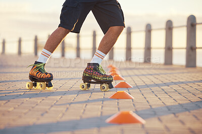 Buy stock photo Roller skates, sport and feet with a man riding around cones for training, fitness and exercise on the promenade by the beach. Male athlete roller skating outside for sports, health and recreation