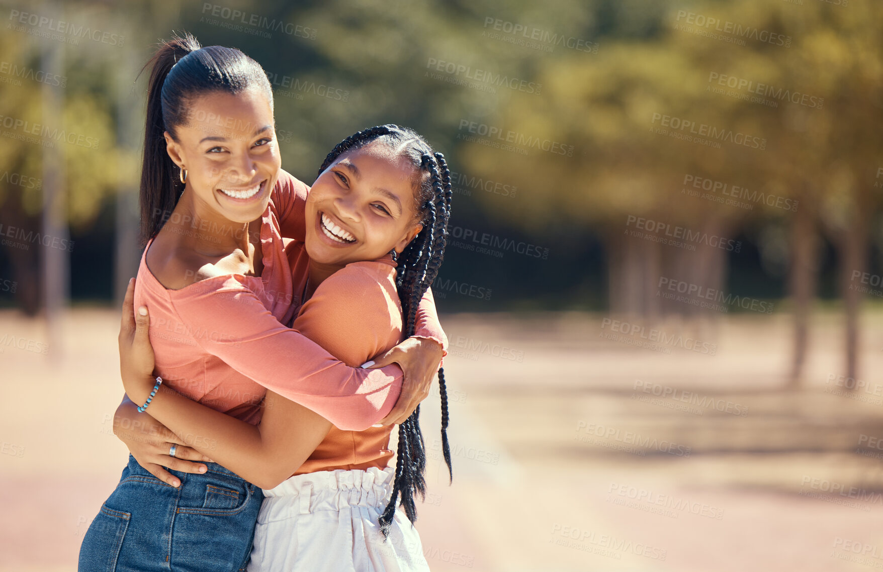 Buy stock photo Portrait of happy friends hugging and smile outside in the park. Happy african american females embracing each other, spending the day together in the forest, enjoying a fun time during summer