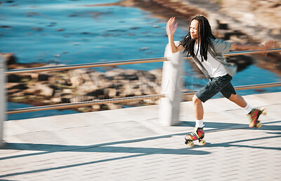 Buy stock photo Freedom, energy and roller skating with black man training and exercise along a beach outdoors. Active African American enjoying intense speed practice of fitness hobby, cardio and balance workout