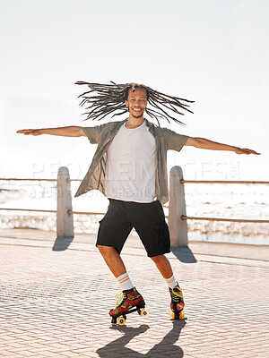 Buy stock photo Training, sports and skate with a man roller skating on the promenade by the beach with the sea in the background. Fitness, fun and freedom with a young male on roller skates outside in summer