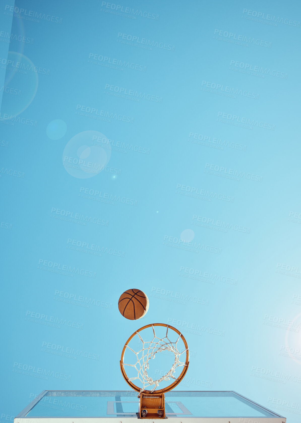 Buy stock photo Basketball, sport and training with a ball and net isolated on a clear sky with mockup from below. Sports, fitness and exercise on a court outside for marketing and advertising on a blue background