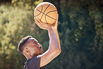 Basketball, sports and exercise workout of a man doing fitness, health and cardio training. Focus mindset of athlete shooting a ball to practice his aim for a sport game or match on a outdoors court