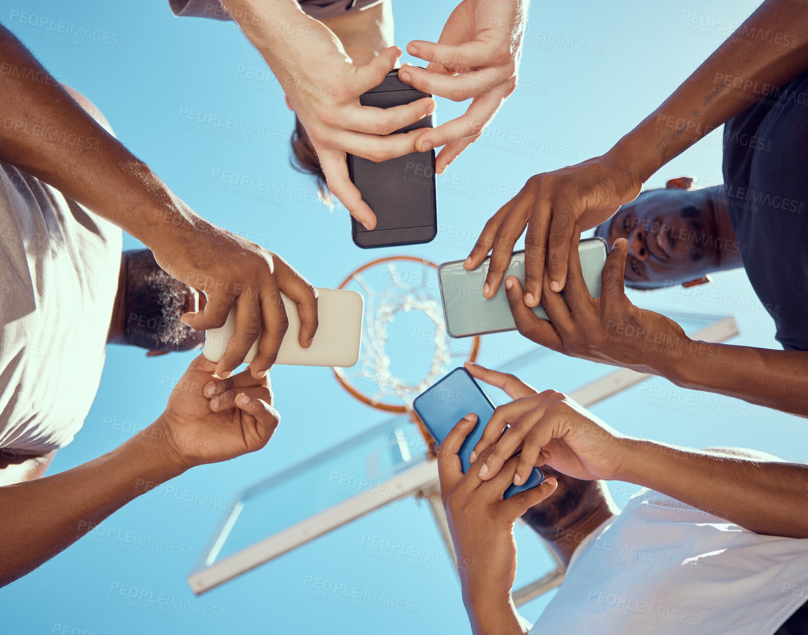 Buy stock photo Basketball team in a circle with phone networking on social media while standing on a court. Sports group doing research on game strategy, collaboration and skill together with technology.