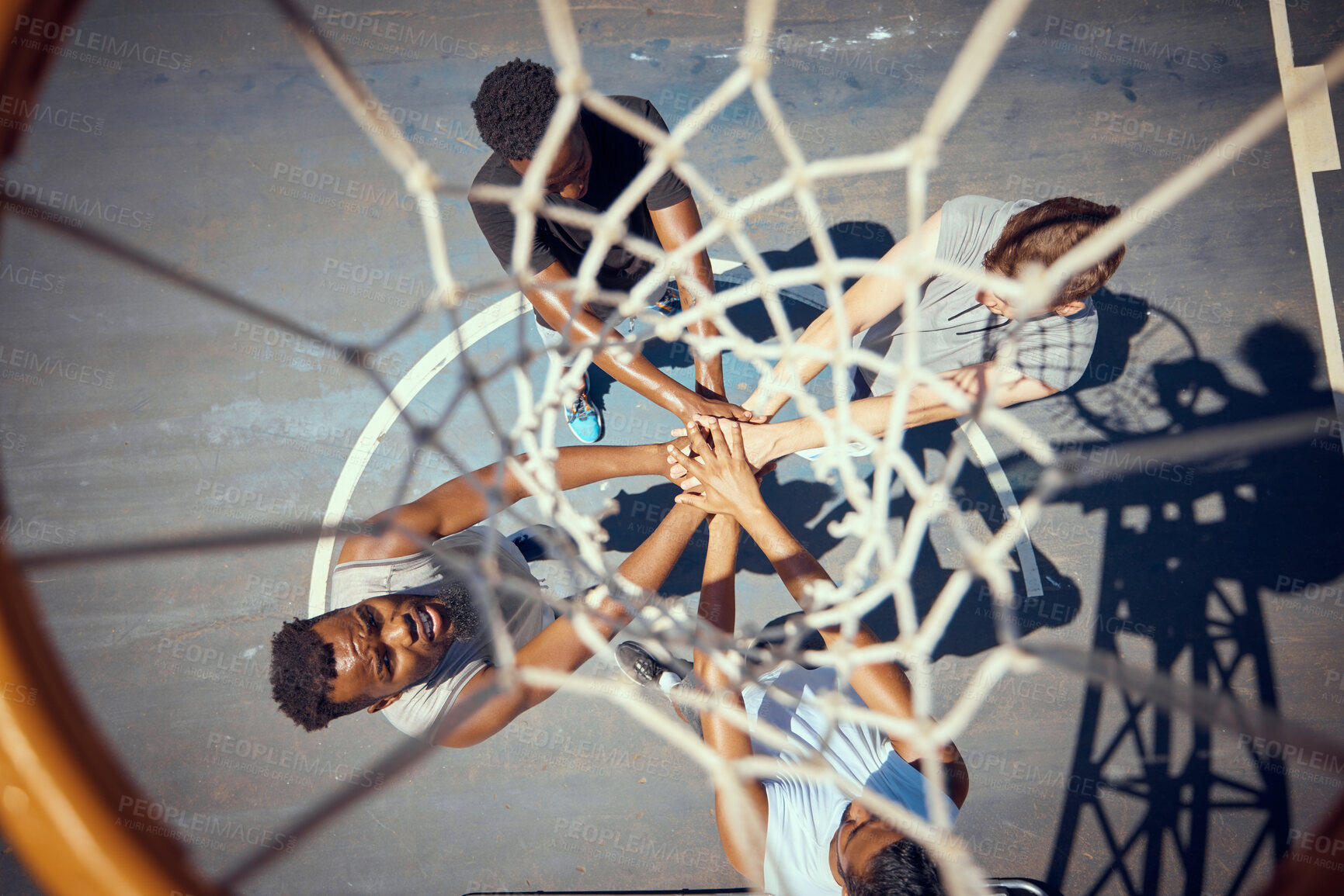 Buy stock photo Basketball, teamwork and sport with a team of basket ball players with their hands in a huddle on a court outside. Collaboration, motivation and fitness with sports people training for health