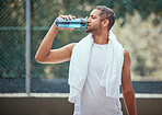 Sports, fitness and man on break drinking water after a workout, training session or exercise. Health, athlete and male trainer resting with refreshing liquid after playing a sport, running or cardio