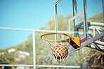 Basketball court, sport and hoop or ring net against a blue sky outside. Score and performance during sports, competition and game outdoor. Background of rim, goal and target in competitive mtach
