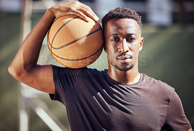 Buy stock photo Portrait african american man standing with a basketball on the court. Fitness male athlete or player holding a sports ball after playing, training and practice game in the background on a court