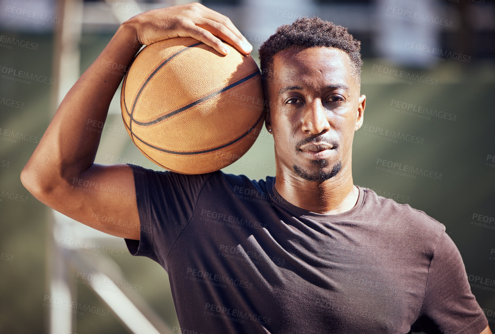 Buy stock photo Portrait african american man standing with a basketball on the court. Fitness male athlete or player holding a sports ball after playing, training and practice game in the background on a court
