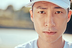 Sports, tennis and portrait of a sweating man with vision, goal and mission for game, competition or outdoor practice with sunshine. Young asian professional player with a serious or determined face