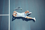 Tired tennis sports man with racket on court in summer and from above. Fitness, sport and professional player resting, taking break or relax in sunshine after match, game or outdoor practice session