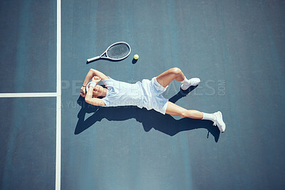 Buy stock photo Tired tennis sports loser man on floor with racket, ball and court in summer sun from above. Relax and fitness player lying on ground, resting or taking break after match, game or outdoor practice