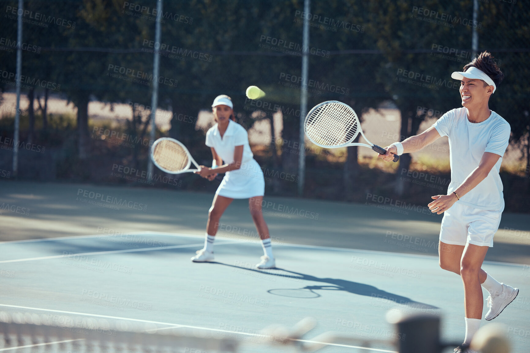 Buy stock photo Fitness, fun and a couple playing tennis on a court outside and happy in the sun. Health, exercise and partners in a weekend game together. Action, teamwork and a man and woman in a match in sunshine