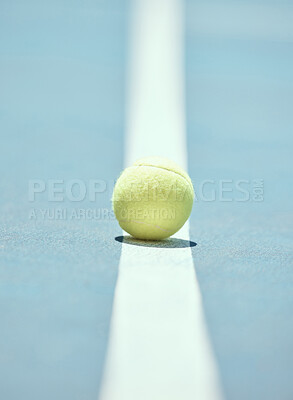 Buy stock photo Tennis ball on the floor of a sports court during practice for a match in summer outdoors. Closeup of equipment for athlete team to train their strategy and skill for exercise and a game at stadium.