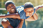 Black family, child or father on a basketball court while having fun and playing plane on a sunny day. Smile portrait of happy and excited kid with man sharing a special bond and close relationship