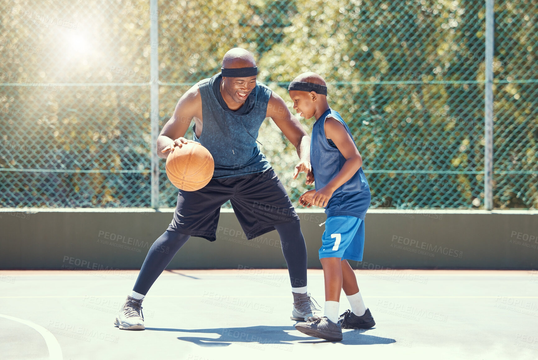 Buy stock photo Basketball, family and teaching sport with a dad and son training on a court outside for leisure fitness and fun. Black man and kid doing exercise and workout playing a game for health and recreation