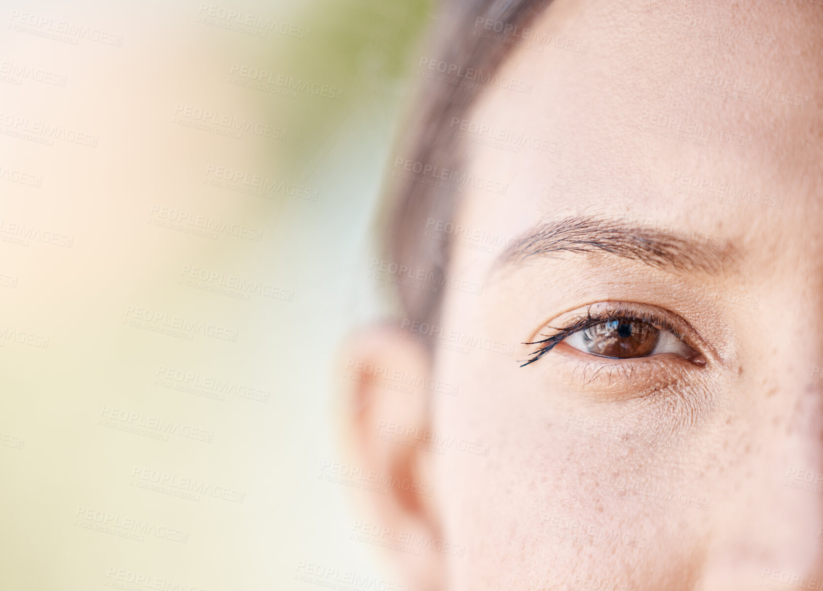 Buy stock photo Face portrait of a woman eye thinking with mockup or blurred background with bokeh. Head of a serious or focus young female with light freckle skin, staring with brown eyes outdoors in nature