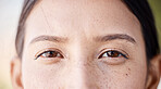Woman, freckles and portrait of natural eyes closeup with thinking and idea facial expression. Young girl with bare face, beauty and healthy skin spots and brown iris for skincare campaign.