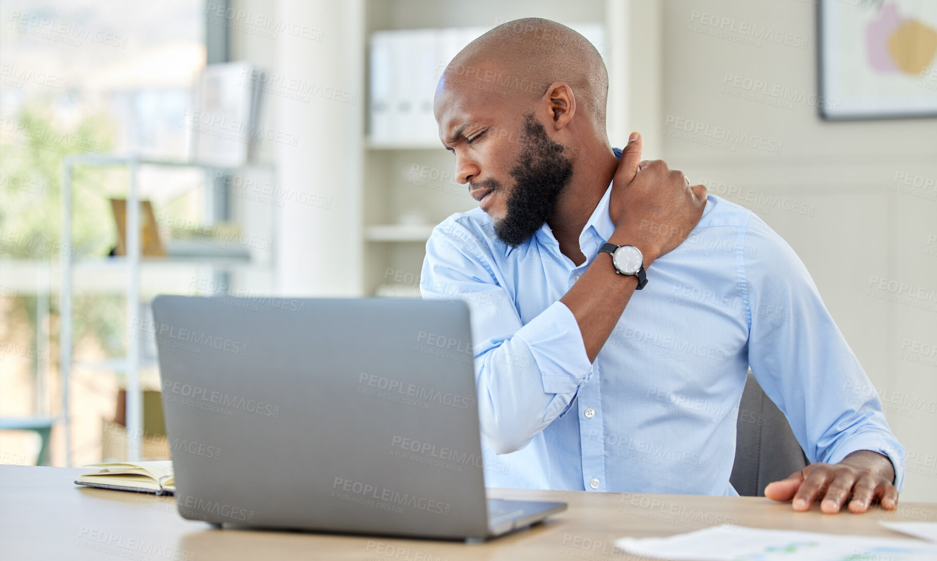 Buy stock photo Black man, shoulder pain on laptop in stress and injury suffering from overworking at home. Stressed African male holding sore muscle, tension or joint inflammation sitting with computer and work