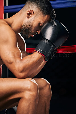 Buy stock photo Boxing gloves, boxer sports man in fight match or prepare for tournament Fitness, training and strong or powerful young prizefighter sitting in a ring thinking of technique, motivation or challenge