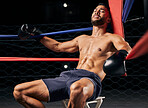 Fitness, boxer and man tired in ring out corner exhausted from sports boxing match at the gym or arena. Active male in fight club, fatigue and relaxing from intense fighting sport workout or exercise