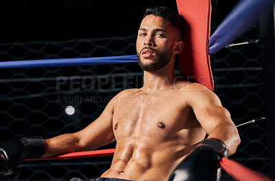 Buy stock photo Boxing, sport and workout with a male boxer in the ring for a fight, match or training. Health, fitness and exercise with a strong sports man resting between rounds of a fighting competition 