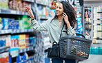 Happy supermarket, grocery shopping and customer with 5g phone call, smile and in retail store for food, groceries or product from shelf. Woman with smartphone, communication of sale in the shop
