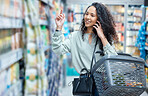 Grocery shopping, woman and phone call of a person using technology in a store. 5g internet, web and mobile communication of a happy female with a smile buying food stock on a digital conversation