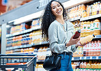 Woman with choice grocery shopping for juice in store, customer with healthy diet in supermarket and happy with retail sale on food at market. Portrait of girl with smile at shop for health drink