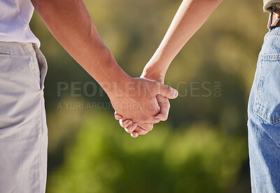 Buy stock photo Hand, love and couple with a man and woman holding hands outside in care, trust and relationship. Closeup of a male and female walking outside together for romance and affection with trust outdoors