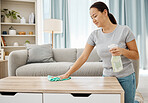 Cleaning table, natural bottle and Asian woman working to keep her living room clean in home, spray for clean desk and happy with product results. Cleaner with housekeeping service in apartment