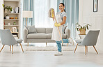 Cleaning, chores and hygiene with a woman cleaner or domestic worker with a mop in a house to clean, tidy and wash. Housework, hygienic and sanitizing with a young female in a home living room