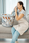 Clean laundry, happy woman and smelling fabric, fresh scent of clothes and washing basket of linen textile at home. Young, smile and asian person, housekeeping service and domestic cleaning lifestyle