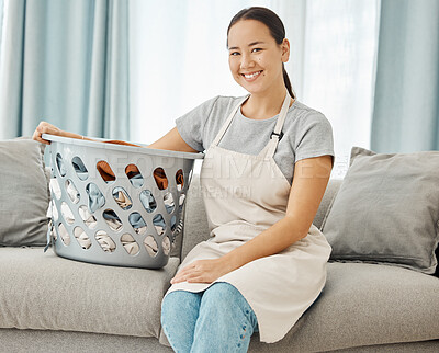 Buy stock photo Cleaning, laundry and happy asian woman with on the sofa with a basket about to do washing of fold clothes in the living room at home. Portrait face housewife or maid doing chores and housework