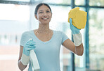 Home, window and woman cleaning her house windows with glass washing cleaner spray. Spring clean job of a happy house maid worker, employee and staff smile busy working in a household to make it tidy